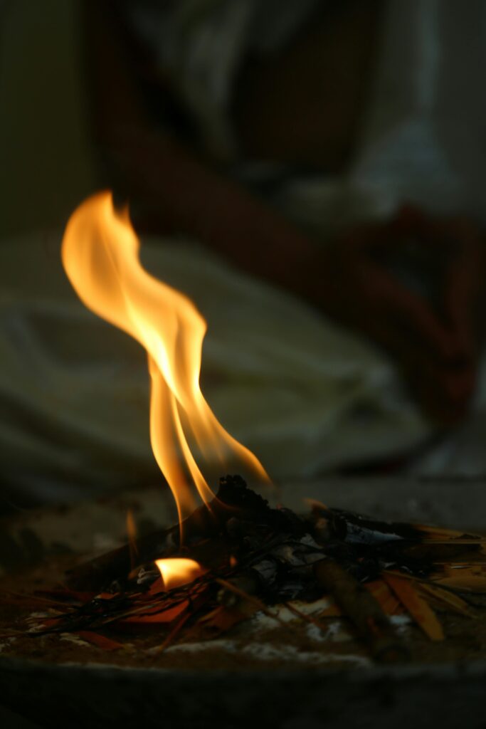 Close-up view of a mesmerizing flame engulfing firewood, creating warmth indoors.
